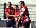 WELL DONE, MATE: David Cookson (left) and Rob Foxen congratulate scorer Chris Murphy, who bagged Oldham’s seventh try. 