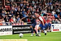 TOUCHLINE DUEL . . . new signing Connor Brown (right) battles with a York defender. 