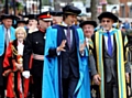 LEADING the way . . . Professor Brian Cox regales Sir Patrick Stewart as they lead the procession through Oldham town centre 
