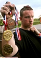 FISTFUL OF MEDALS: Mark Doyle shows off the sppils of his efforts in the Great Britain Open Karate Championships. 