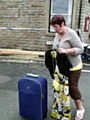 RELIEF . . . . Marjorie Coppinger with her dress and suitcase 
