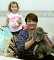 Happy to be back home . . . Sam Perry, with daughter Amelia and cat Asbo 
