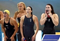 LET'S hear it for the girls: Diggle's Jessica Lloyd (right) joins teammate Amy Smith in support of swimmers in the women's 4x100m freestyle relay. 