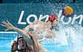JOE O'Regan (blue cap) battles for the ball in the water polo preliminary Group ‘B’ match against Romania. 