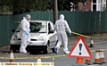 ALERT: bomb disposal and forensics officers check the car 
