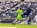 Simpson tangles unsuccessfully with MK Dons goalkeeper David Martin 