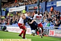 ROBBIE Simpson is sent tumbling under a Stevenage challenge. 
