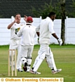 LEADING FROM THE FRONT . . Crompton skipper Carl Taylor celebrates taking the wicket of Oldham’s Atif Riaz with wicketkeeper Dave Clegg.  
