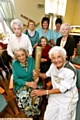 BIRTHDAY surprise: Olympic torch bearer Thora Beddard shares the torch with Amy Barrell and residents at Millfield 

