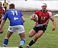 acton man: Jamie Acton, head bandaged, runs hard at the Workington defence. 