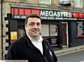 GOING for growth: John Salt outside his Lees shop 
