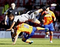 COLLISION COURSE . . . Dean Furman is bundled to the ground as Harry Forrester produced a committed challenge for Brentford. 