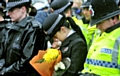 A police officer bows her head during the vigil, which included a minute’s silence 