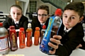 RUNNING dry: Newman College pupils (from left) Maria Humphries, Patrick Scott and Kyle Rhodes with some of the banned energy drinks 

