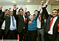 Victorious: Zahid Mehmood Chauhan (front, second left) pictured with (fom the left) councillors Fida Hussain, Jenny Harrison, Labour leader Jim McMahon and Shoab Akhtar and other supporters 