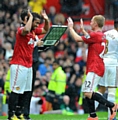 United's Paul Scholes (centre right) is greeted by team-mate Oliveira Anderson as he is substituted. 