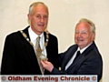 Councillor Brian Lord hands over the ceremonial chains to the new Saddleworth Parish Council chairman, Councillor Graham Sheldon 
