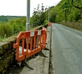 BLOCKED . . . barriers around lamp posts in Sugar Lane, Dobcross force pedestrians into the road 
