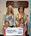 HEARTFELT thanks . . . Sarah Taylor (left) Pauline Holt, and Sarah’s children Emily and Holly hand over a cheque to Dr Kershaw’s in memory of Kenny 
