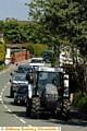 PROCESSION . . . a tractor leads the cortege of Land Rovers 
