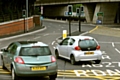 CLOSE call . . . these two cars almost collide as they attempt to join the lanes to approach the bypass