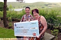 FEELING flush . . . work colleagues Lynn Molloy and James Hartley celebrate their big win at the Saddleworth Hotel 

