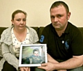 MICHELLE and KENNY HEATON with a picture of their beloved Jamie 