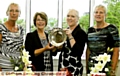 ALL YOURS: Audrey Whittaker (second left) receives the Crompton and Royton Lady Captain’s Day trophy from lady captain Lynn Truelove. They are flanked by Brenda Keaney (left, first-day prize) and Jennifer Kenworthy (second-day prize). 