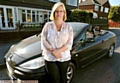 Clare with the car she will drive in the carnival. 
