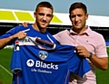 NEW KID ON THE BLOCK: Anton Rodgers gets a warm welcome from Athletic manager Lee Johnson. 