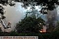 DOUSING the flames: firefighters used hydraulic platforms to get to the blaze. 