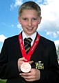 Alfie Astley, showing off his bronze medal from the qualifying gala, won gold in the double mini trampette in Birmingham. 