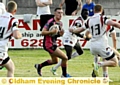 FIVE ON ONE: Oldham’s Tom Whitehead tries to spot a gap. 