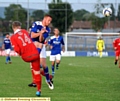 COLLISION COURSE . . . Adam Rooney charges down a Curzon Ashton clearance at the Tameside Stadium last night. 