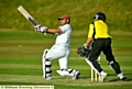 TAKE THAT . . . Delph’s Faisal Butt finds the boundary. 