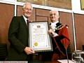 HONOUR: Oldham Mayor Councillor John Hudson presents Mr Meacher with a framed scroll. Picture: Anthony Miller 
