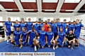 RARING TO GO . . . Eric Noi poses with the Athletic players before the tough work-out. 
