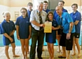 LIFEsaver . . . Caoimhe Preshur (centre) receives her Certificate of Commendation for her brave actions from RLSS UK Manchester and district branch chairman Mike Wardle alongside Rookie Lifeguard instructor Warren Andrews and fellow Rookies 
