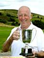 JUST CHAMPION . . . Richard Hughes shows off his trophy 