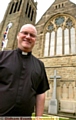 CHURCH repairs: Father David Hawthorn outside St Margaret’s Church 

