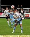 up and over: James Blair, of Mossley, beats his Kendal Town opponent to the ball in the Evo-Stik Division One North opener at Seel Park. 