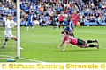 STOOP TO CONQUER: Charlie MacDonald dives to head home and give Athletic a glimmer of light in the closing stages at London Road.