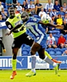 New man Jabo Ibehre tussles with Athletic’s Genseric Kusunga on the opening day of the season