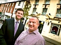 STEP back in time: the iconic Grapes Hotel will soon be resurrected. Council leader Jim McMahon is pictured with Guy Barlow in the Independent Quarter
