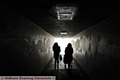 PEOPLE walking under the subway’s broken lights. 