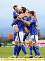 James Dayton jumps into the arms of Jonathan Grounds after the defender’s equaliser for Athletic. Pictures by VINCENT BROWN and ALAN HOWARTH 
