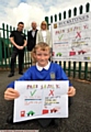 SAFETY check . . . Will Collinge with his original artwork used in the new safety banner. Standing behind are Chris Gledhill (left), from Sign UK Ltd, and school governors James Woodward and Sarah Parker 