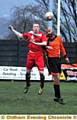 UP AND AT ’EM: Damien Schofield (right) beats his rival to the ball.