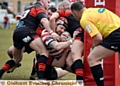 Oldham’s Michael Ward is held up just short of the line by a clutch of Kells defenders. PICTURE by TIM BRADLEY
