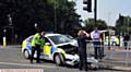 CRUNCH . . . the damaged police car embedded in railings at the junction of Lees Road and Cross Street